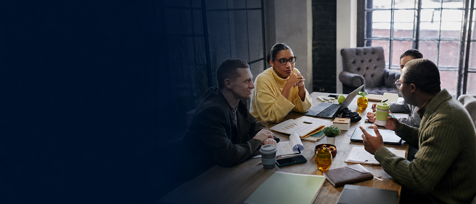 Benefits professionals discussing a plan around a conference table